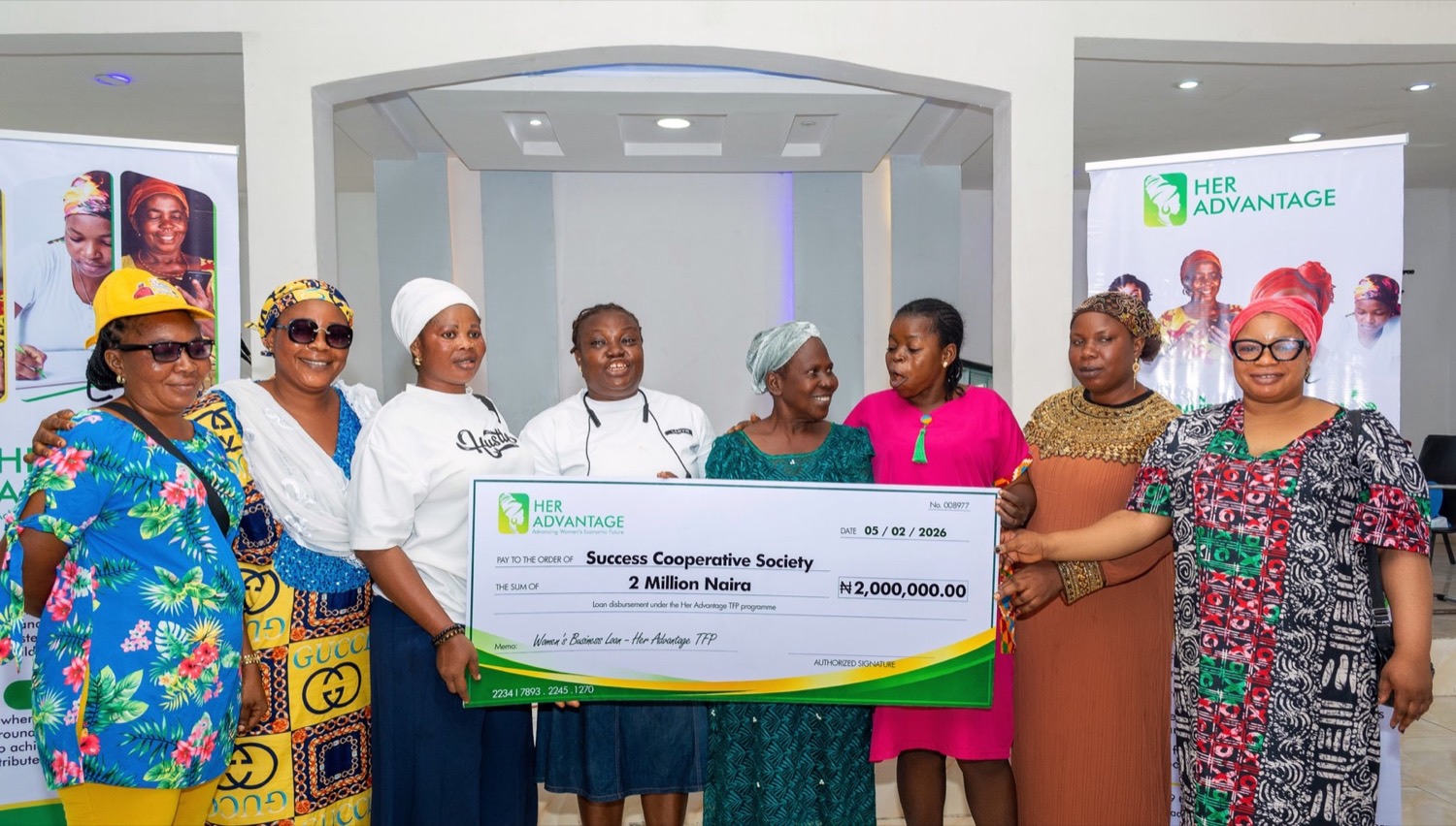Her Advantage programme participants holding campaign placards