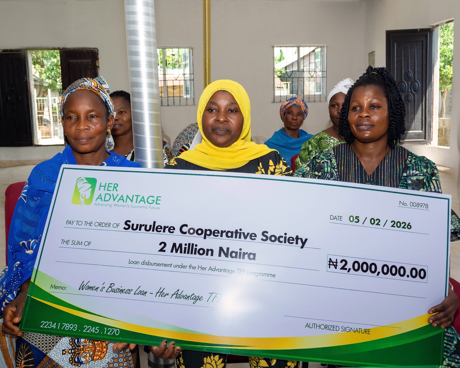 Members of Surulere Cooperative Society receiving a ₦2,000,000 cheque